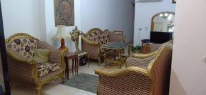 a living room with a bunch of chairs and a table at Smoha Zahran Haus (Private rooms or Private Apartment) in Alexandria