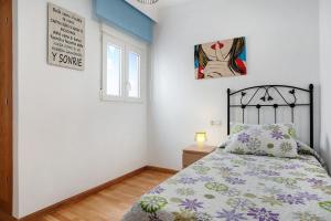 Łóżko lub łóżka w pokoju w obiekcie Apartamento Sol - Sólo Familias