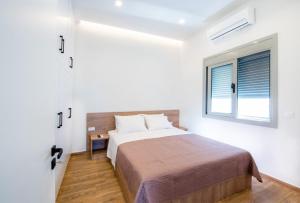 a bedroom with a bed and a window at Dias Luxury Homes in Koskinou +11 photos