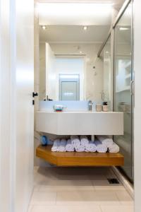 a bathroom with a sink and a counter with towels at Dias Luxury Homes in Koskinou