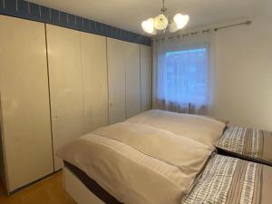 a bedroom with two beds and a window at Ferienwohnung Leo in Bad Endorf