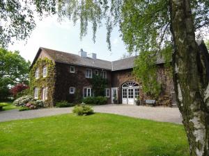 a large brick house with a grass yard at Ferienwohnungen Knospe in Kappeln