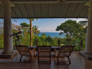 a view of the ocean from the porch of a house at Villa SPACE in Unawatuna