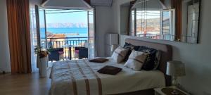 een slaapkamer met een bed en uitzicht op de oceaan bij Beautyful sea view 6 luxury studio Danijela in Senj