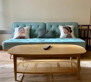 a blue couch with pillows and a coffee table at Au cœur des Remparts de Guérande: logement pour 4 in Guérande