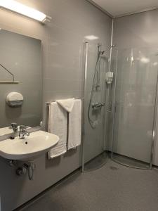 a bathroom with a shower and a sink and a shower at Fjellfolkets Hus in Hattfjelldal