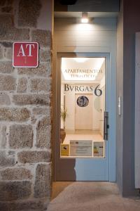 a display window of aarmakritos furniture store with a sign at Apartamentos Turísticos As Burgas 6 by Bossh Hotels in Ourense