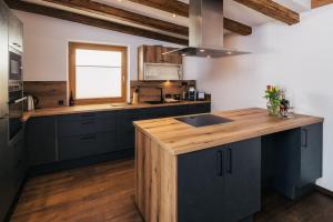 a kitchen with blue cabinets and a wooden counter top at Serfaus Alpensuites in Serfaus