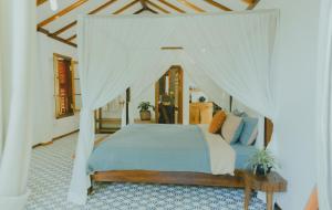 um quarto com uma cama de dossel em The Wooden Gate em Xuân Sơn