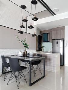a kitchen with a black table and chairs at Bella Maison @ Sunway Velocity 中文房东 in Kuala Lumpur