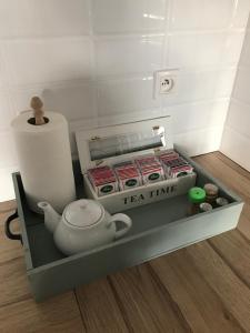 a tea time box with a teapot on a shelf at Apartament Wigilijna Starówka in Elblag