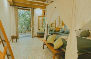a bedroom with a bed with a canopy at The Wooden Gate in Xuân Sơn
