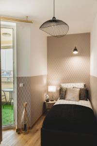 a bedroom with a large black bed and a window at ClickTheFlat Gdański Center Prestige Apart Rooms in Warsaw