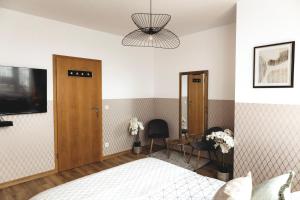 a bedroom with a bed and a table and a mirror at ClickTheFlat Gdański Center Prestige Apart Rooms in Warsaw