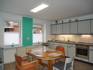 a kitchen with a table and chairs in a kitchen at Ferienwohnung Mecklenburgische Seenplatte in Schwichtenberg