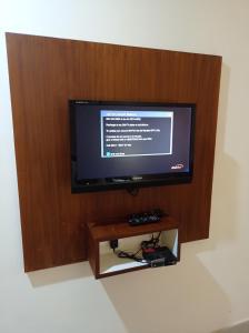 a flat screen tv sitting on a wall at Hotel Emerald Regency in Putuppalli