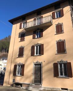 a tall building with windows and a door at Casa Olmo Vacanze in Olmo al Brembo