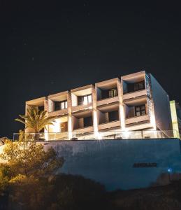 an apartment building at night with its lights on at Apollo Resort in Agia Marina Aegina