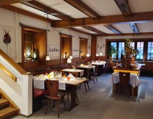 a restaurant with tables and chairs in a room at Landhotel Mühle zu Gersbach in Gersbach