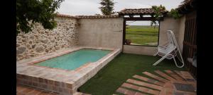a swimming pool in a yard with a patio at LA CASA DEL BUHO in Santa María la Real de Nieva