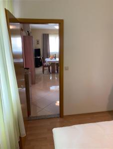 a room with a door leading to a dining room at Apartment "Onkel" in Šibenik