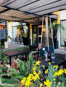 a patio with two tables and chairs and flowers at Trilussa Palace Hotel Congress & Spa in Rome