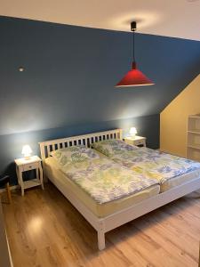 a bedroom with a bed and two night stands at Ferienwohnungen Koch OG adult only in Wangerland
