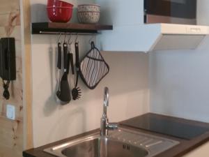 a kitchen counter with a sink and utensils at Zirbenstüberl - Chiemgau Karte in Inzell +19 photos