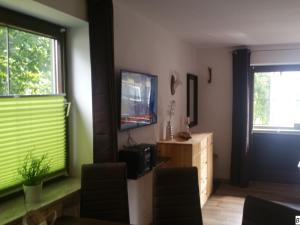 a living room with green blinds on the windows at Zirbenstüberl - Chiemgau Karte in Inzell