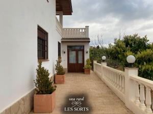 a walkway leading to a house with a wooden door at Casa rural Les Sorts in Rosell