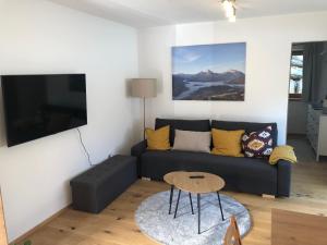 a living room with a couch and a table at Fewo Glücksfall in Berchtesgaden