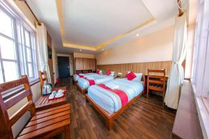 a group of four beds in a room at Hotel Chhimeki in Kathmandu