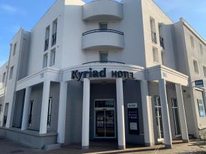 a white building with the name of a hotel at Kyriad Lille Gare - Grand Palais in Lille