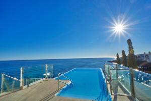 a swimming pool on the deck of a boat in the ocean at Hotel Balcón de Europa in Nerja