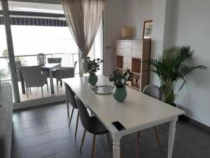 a white table with vases on it in a living room at Roses Casc Antic SL Avda Rodhe in Roses