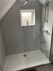 a shower in a bathroom with a window at The Cedars Ashby in Ashby de la Zouch +32 photos
