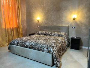 a bedroom with a bed with a leopard print blanket at Residence Giove in Castelfranco Veneto