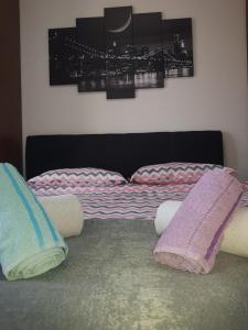 a bed with two pillows on top of it at Family Apartmani Le in Leskovac