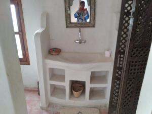 a bathroom with a sink with a fireplace in it at Luxury Camp desert Maroc Tours in Mhamid