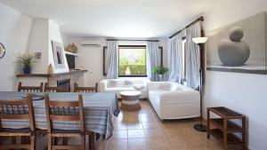 a kitchen and living room with a table and chairs at Can Seguinot in El Port +22 photos