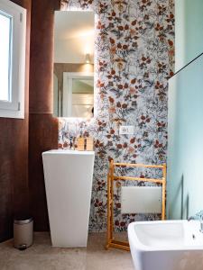 a bathroom with a sink and a mirror at B&B Sole Mare Luna in Lu Lioni