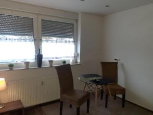 a room with two chairs and a table and two windows at Alsdorf 3 in Alsdorf