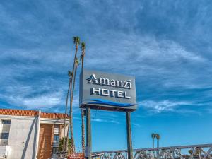 a sign for an amana hotel with palm trees at Amanzi Hotel, Ascend Hotel Collection in Ventura