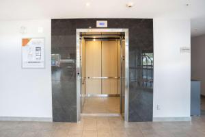 a hallway with a door in a building at Quality Inn in Quebec City