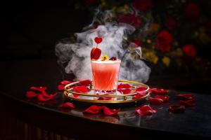 a drink with a strawberry on a table with smoke at Roslin Beach Hotel in Southend-on-Sea