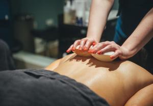 a woman getting a back massage from a man at Roslin Beach Hotel in Southend-on-Sea