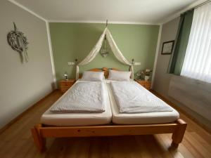 a bedroom with two beds in a room with a window at Gasthaus Holdermühle in Creglingen