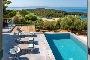 a villa with a swimming pool and a view of the ocean at Villa Benedetta Unique Privacy And Sea View in Sivota