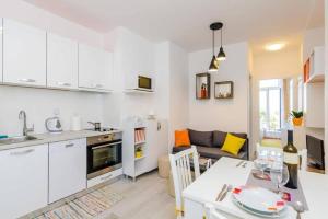 a kitchen and a living room with a table in a kitchen at Dubrovnik: Apartment Quiet Corner in Dubrovnik