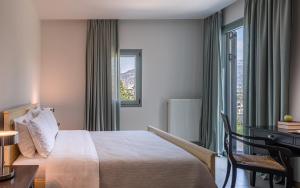 a hotel room with a bed and a desk and a window at Villa Benedetta Unique Privacy And Sea View in Sivota +16 photos